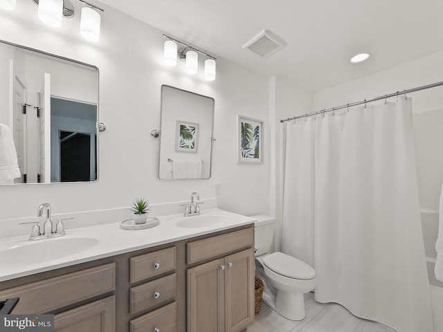 bathroom featuring toilet and vanity