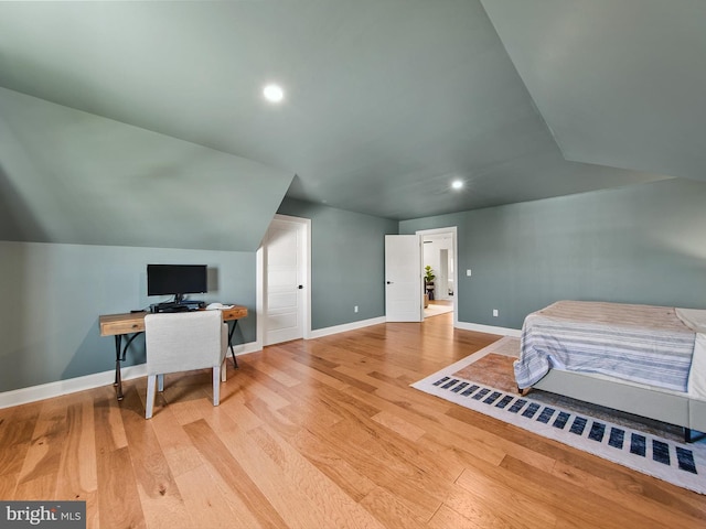 bedroom with light hardwood / wood-style floors and vaulted ceiling