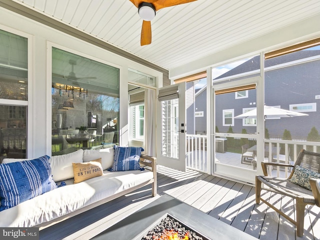 sunroom / solarium featuring ceiling fan