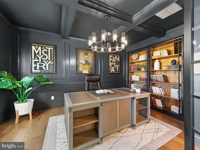 home office with ornamental molding, beam ceiling, coffered ceiling, an inviting chandelier, and light hardwood / wood-style flooring