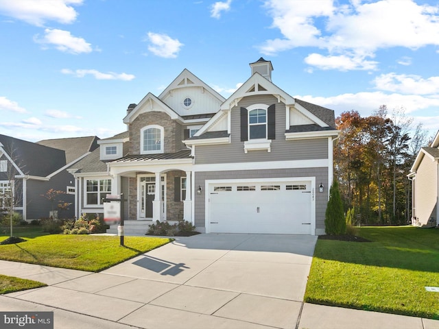 craftsman house with a garage and a front yard