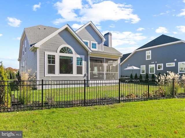 view of front of house featuring a front lawn and a sunroom