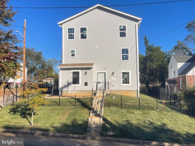 rear view of property featuring a yard