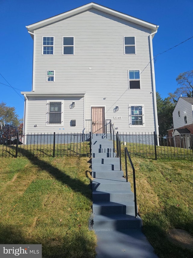 rear view of house with a yard