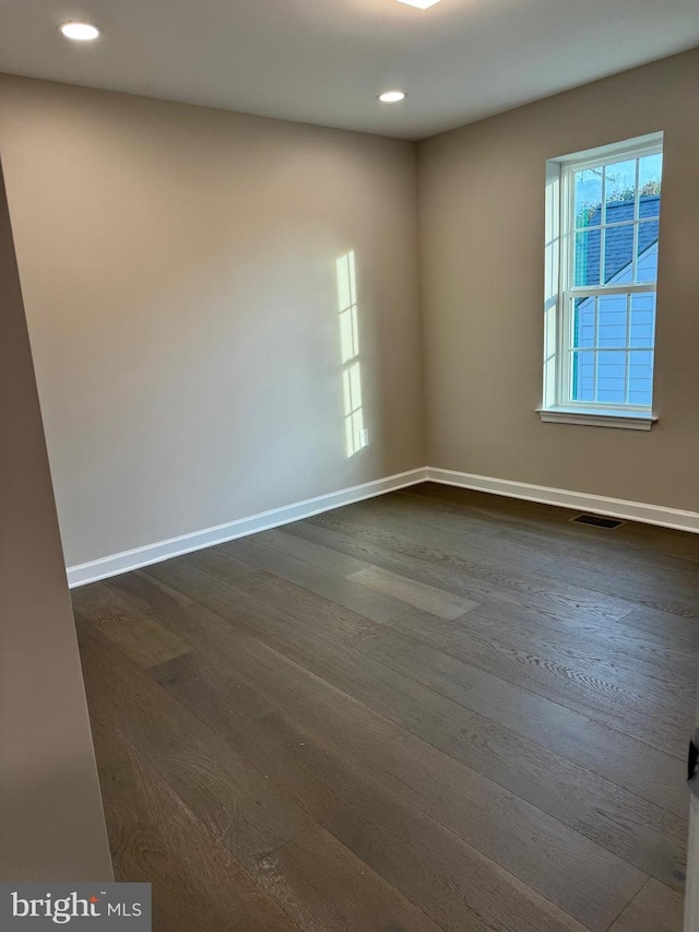 empty room featuring dark hardwood / wood-style floors