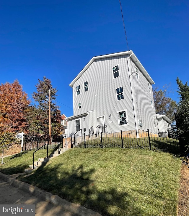 rear view of property with a yard