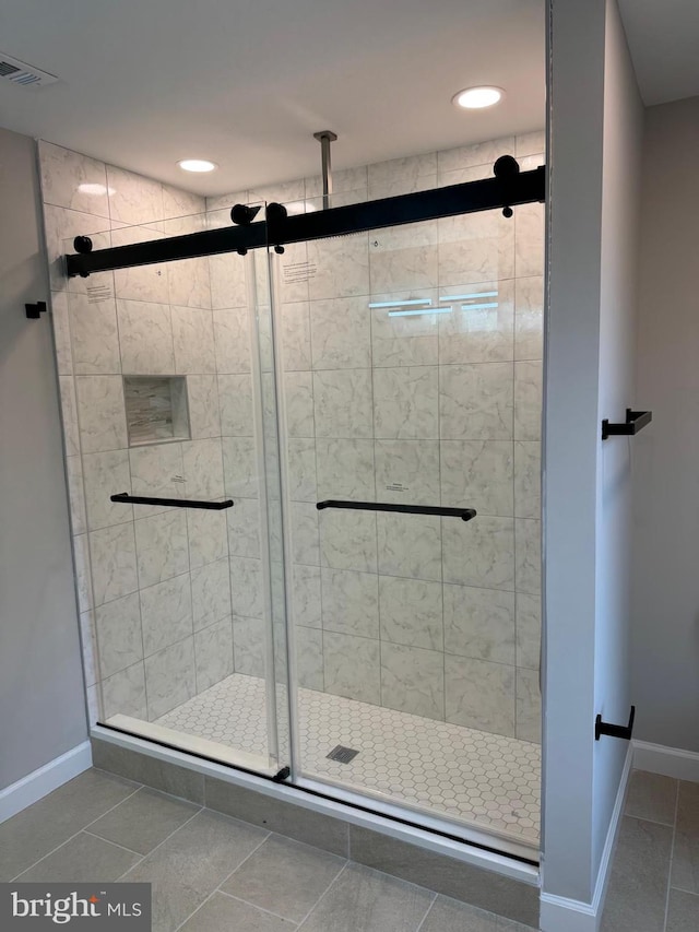 bathroom featuring walk in shower and tile patterned floors