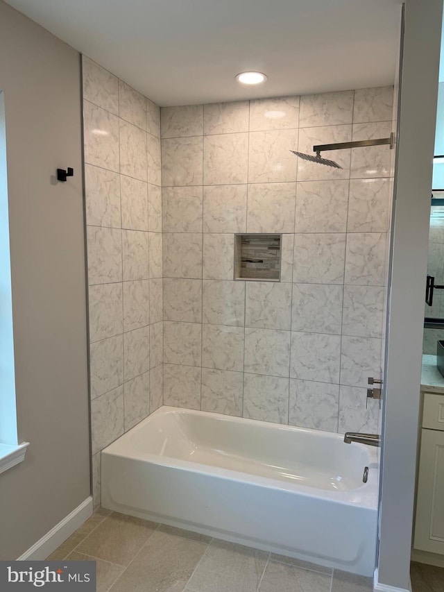 bathroom featuring tile patterned flooring and tiled shower / bath combo