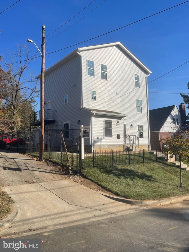 back of house with a lawn