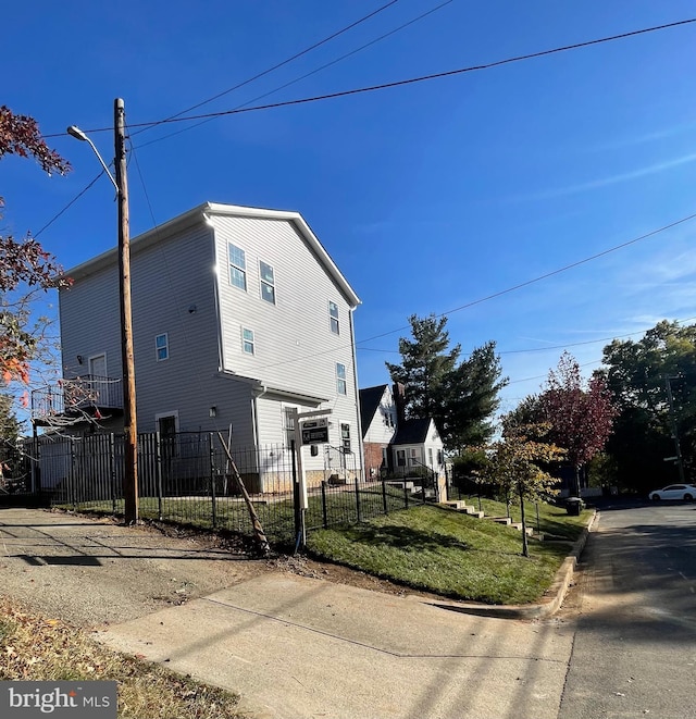 view of side of home featuring a yard