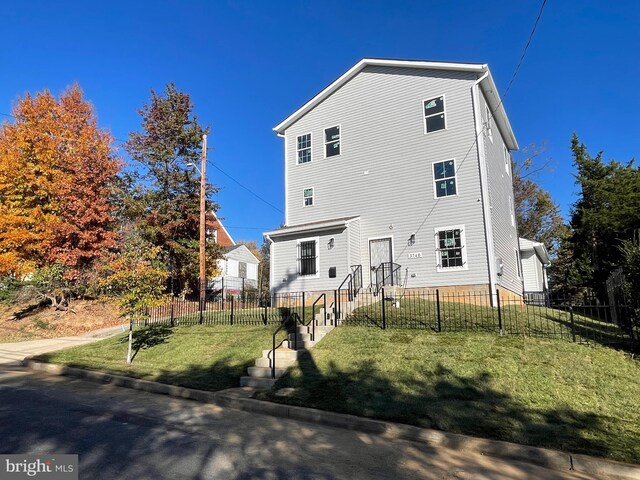 back of property featuring a yard