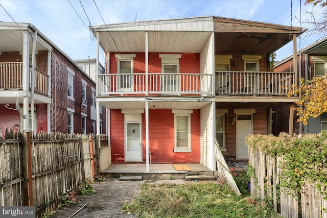 view of front facade with a balcony and a patio area