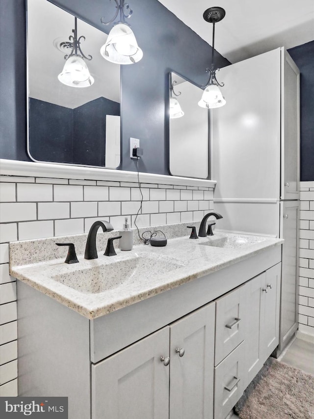 bathroom featuring hardwood / wood-style flooring, vanity, and tile walls