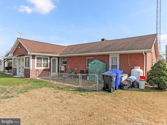 back of property with a lawn