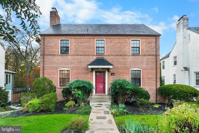 colonial-style house with a front yard