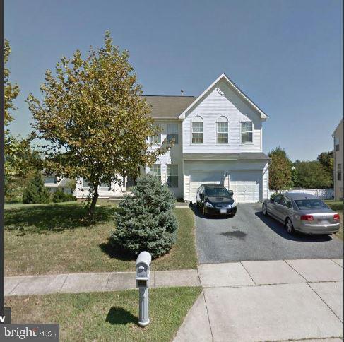 view of front of home with driveway and an attached garage