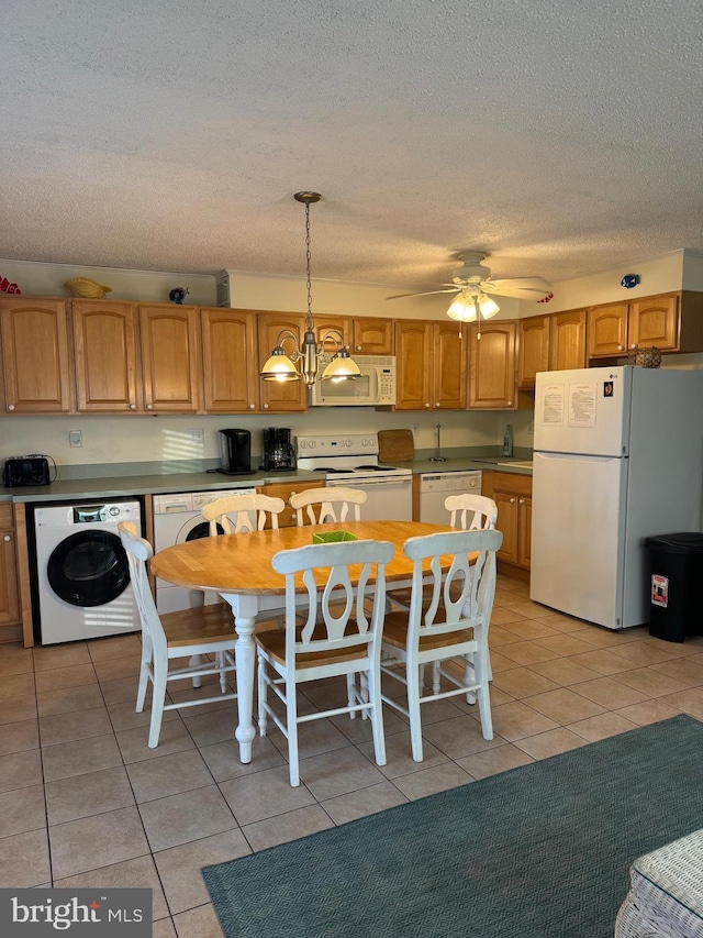 kitchen featuring ceiling fan with notable chandelier, white appliances, decorative light fixtures, washer / clothes dryer, and light tile patterned flooring