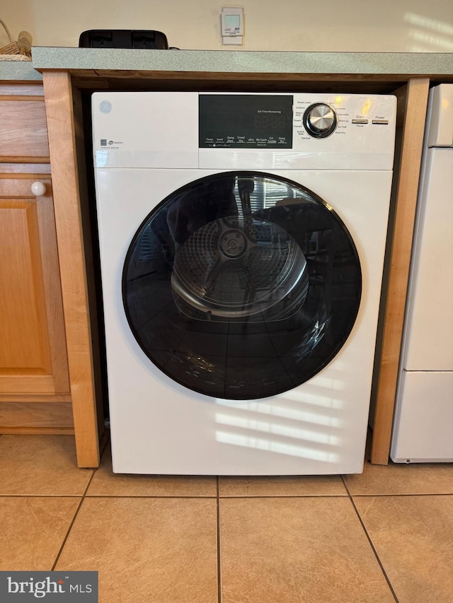 13 75th St Unit 1W, Ocean City, MD 21842 - clothes washing area with light tile patterned floors, washer / clothes dryer, and laundry area