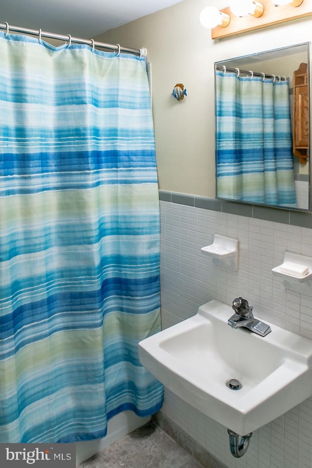 13 75th St Unit 1W, Ocean City, MD 21842 - bathroom with tile walls, a shower with curtain, and a sink