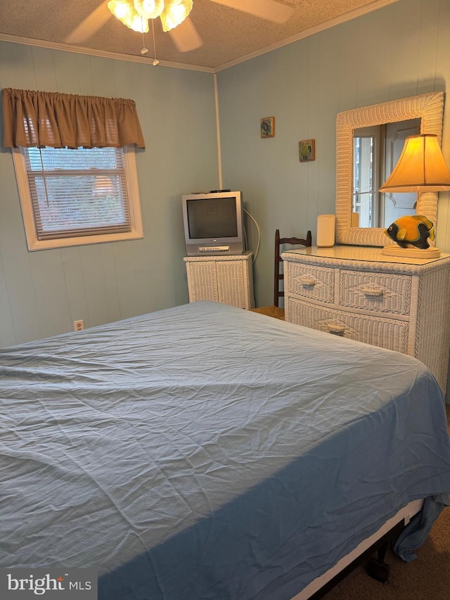 bedroom with a textured ceiling, ceiling fan, and crown molding