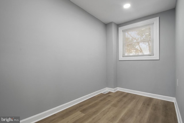 empty room with hardwood / wood-style flooring