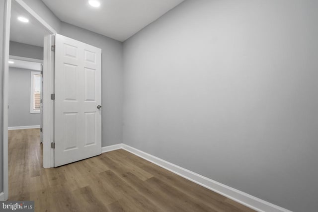 hallway with light hardwood / wood-style floors