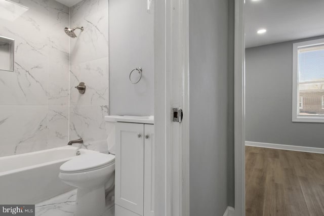 full bathroom featuring vanity, toilet, hardwood / wood-style floors, and tiled shower / bath