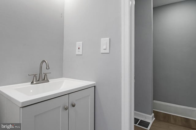 bathroom with vanity and hardwood / wood-style flooring