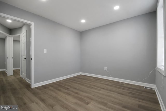 spare room with dark wood-type flooring