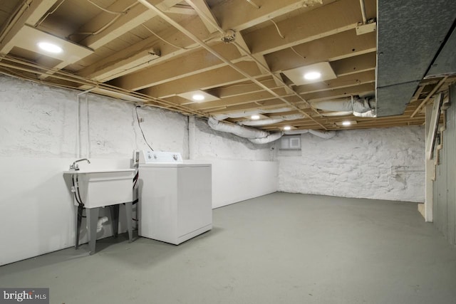 basement with washer / clothes dryer and sink