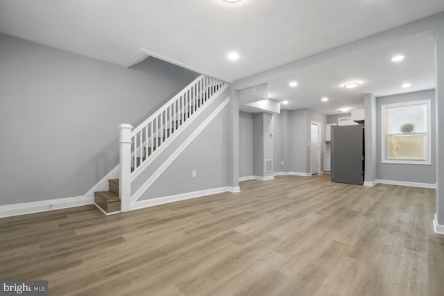 unfurnished living room with light hardwood / wood-style flooring