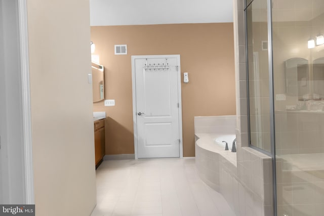 bathroom featuring tile patterned flooring, vanity, and independent shower and bath