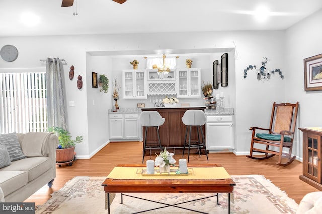 living room featuring ceiling fan and light wood-type flooring