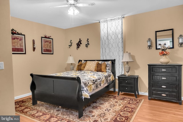 bedroom with ceiling fan and light hardwood / wood-style flooring