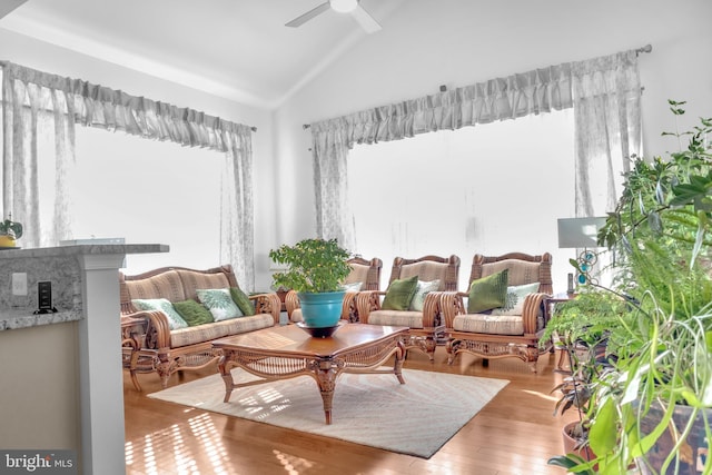 sitting room with ceiling fan, light hardwood / wood-style flooring, and vaulted ceiling