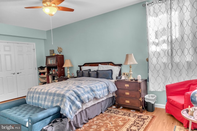 bedroom with ceiling fan, light wood-type flooring, and a closet