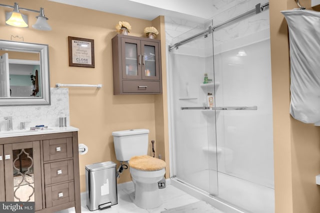 bathroom with vanity, a shower with shower door, and toilet