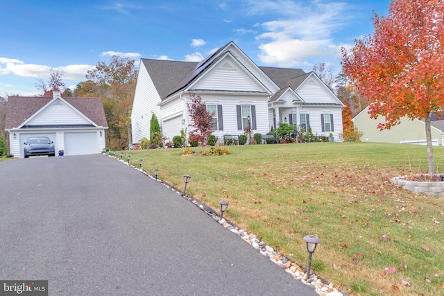 view of front of house featuring a garage and a front lawn