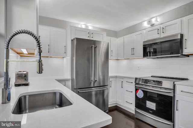 kitchen with white cabinetry, appliances with stainless steel finishes, and sink