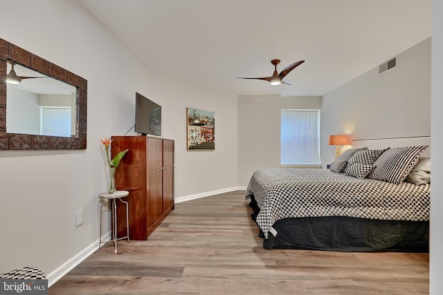 bedroom with ceiling fan and light hardwood / wood-style flooring