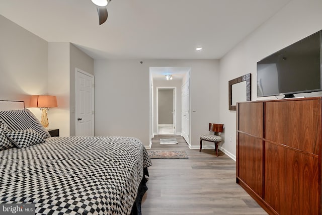 bedroom with ceiling fan and light hardwood / wood-style flooring