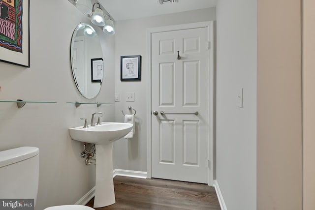 bathroom featuring hardwood / wood-style floors and toilet