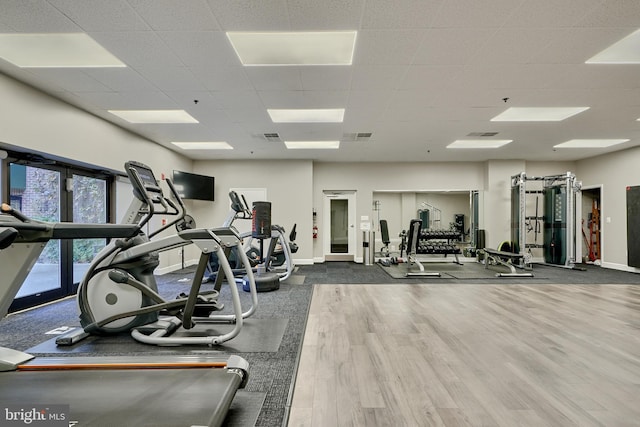 gym with wood-type flooring and a drop ceiling