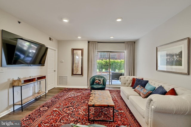 living room featuring dark wood-type flooring