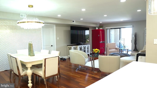 dining room featuring dark wood-type flooring and a chandelier