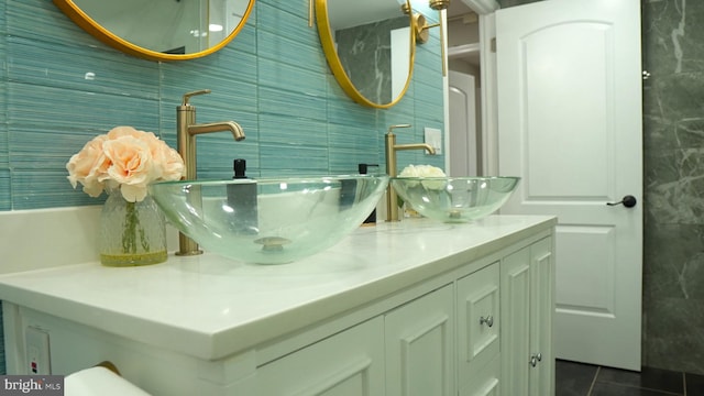 bathroom with tile walls, vanity, and tile patterned floors