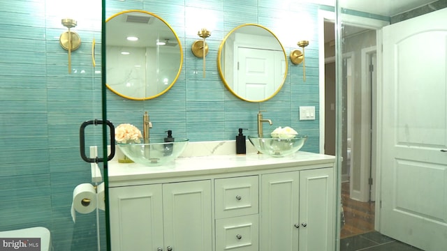 bathroom with tile walls and vanity