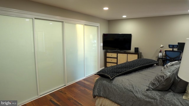 bedroom with a closet and dark hardwood / wood-style flooring