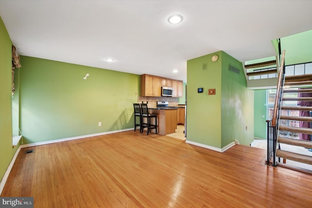 unfurnished living room featuring light wood-type flooring