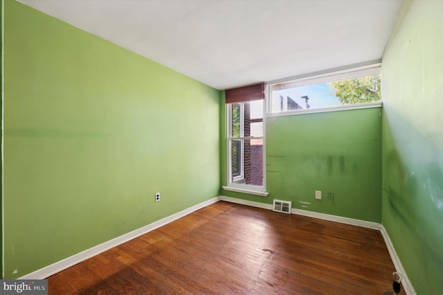 unfurnished room featuring hardwood / wood-style floors